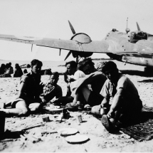 'Tiffin' on Djinna Island, off coast of Saudi Arabia April 1943 with downed Bisley aircraft. Ron Chapman is far left of foreground group of RAF airmen. Ron Chapman was with with RAF Communications Flight, Habbaniya, flying out of Bahrein for the recovery mission.